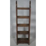 A C.1900 carved oak five tier narrow open bookcase. H.111 W.34 D.15cm