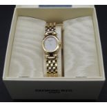 A boxed Raymond Weil gold plated ladies wristwatch with papers. It has an oval face with white