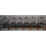 A set of six mahogany Hepplewhite style dining chairs with pierced wheatsheaf backs above stuff over