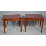 A pair of late Georgian style mahogany lamp tables with inset leather tops on reeded tapering