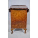 A mid century early Georgian style burr walnut fitted sewing table with drop flap top with pie crust