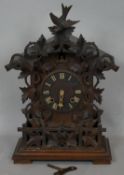 A Junghans Black Forest style cuckoo mantel clock, carved case and maker's mark to the back and with