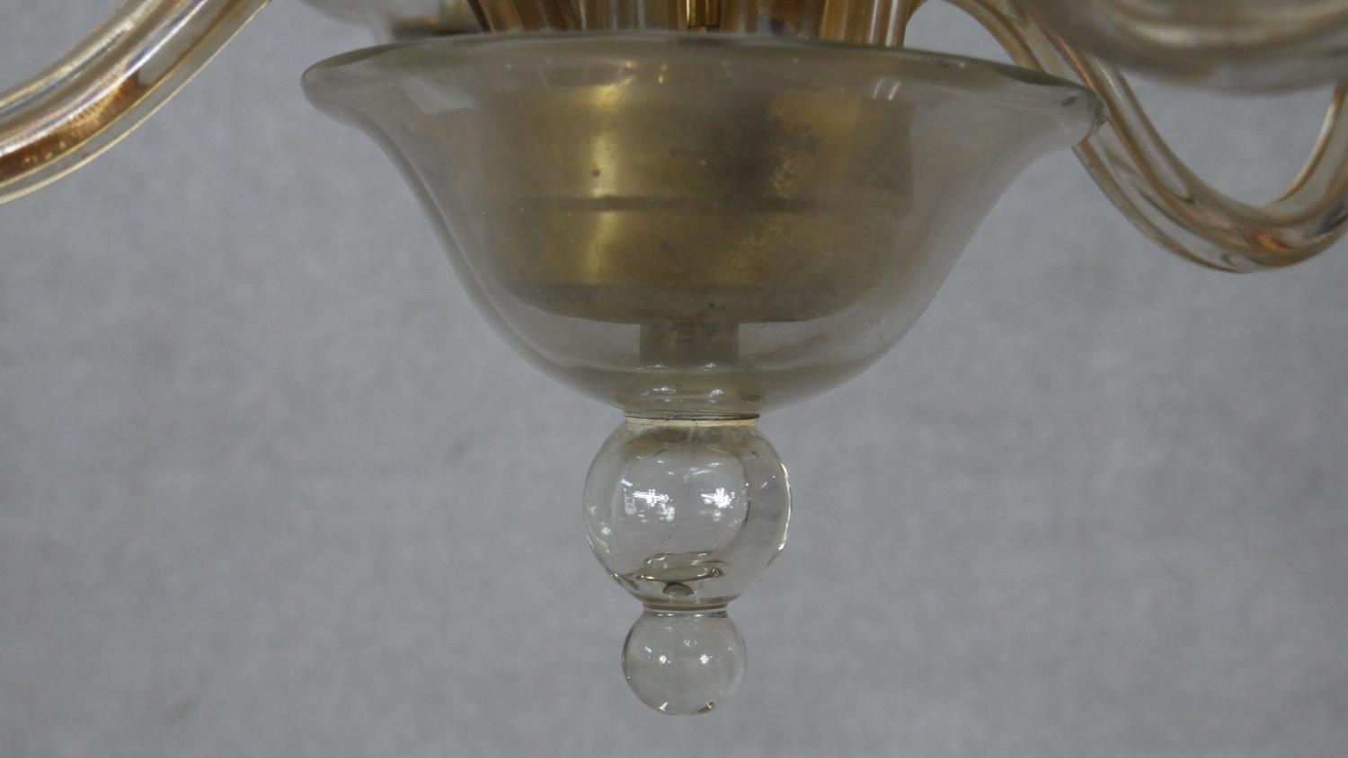 A Venetian style four branch glass chandelier with scrolling arms and finials. D.49cm (small break - Image 3 of 5