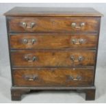 A Georgian mahogany chest of four long graduating drawers with brass swan neck handles on bracket