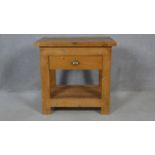 A vintage pine butcher's block style kitchen table fitted with frieze drawer on square supports