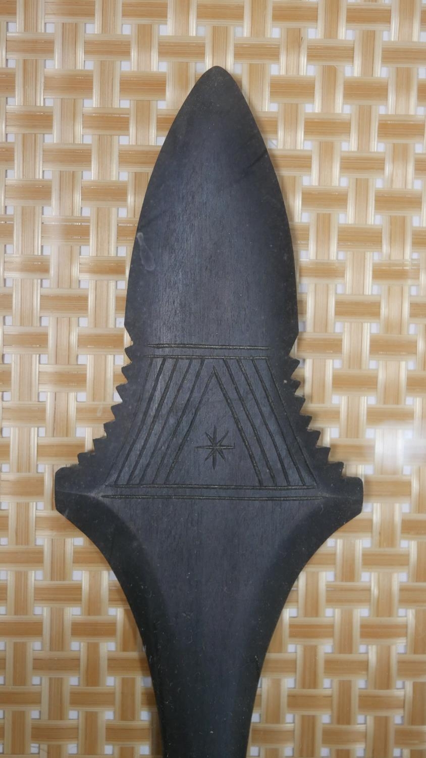 A framed and glazed Asian painted wooden dagger mounted on woven bamboo matting. H.53 W.28cm