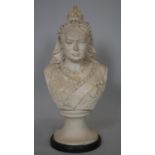 An antique reconstituted marble bust of Queen Victoria on a round ebonised base. H.37cm