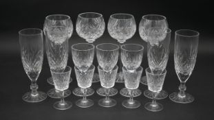 A collection of sixteen cut crystal glasses. Including a set of four foliate design wine glasses,