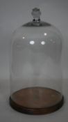 A large antique blown glass bell display dome/bell jar with impressed mark to the handle. It sits on