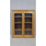 A 19th century pine glazed bookcase on plinth base. H.118 W.96 D.32.5cm