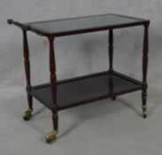 A beech and brass drinks trolley with glass inset top. H.69 L.80 W.42cm