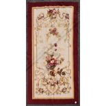 A handmade Aubusson with profuse floral sprays and scrolling vines on a biscuit ground within