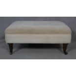 A 19th century style upholstered footstool on turned tapering supports. H.36 L.80 W.59cm