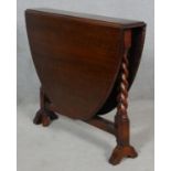 A mid century oak gateleg action Sutherland table on barleytwist supports. H.74 L.127 W.91cm (open)