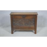 A Jacobean style small coffer with carved panels on reeded block supports. H.58 W.75 D.26cm (a piece