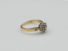 A vintage 18 carat diamond cluster ring, set with an approximately 0.25 carats of brilliant cut