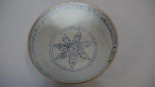 An Oriental blue and white ceramic glazed bowl with floral motif to the inside centre and stylised