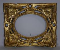 A 19th century giltwood frame with carved shell, swag, ribbon and foliate decoration. H.32 W.38cm