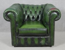 A Chesterfield armchair in deep buttoned leather upholstery. H.71 W.98 D.85cm