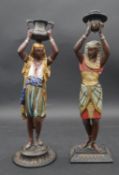 A pair of vintage painted spelter figural candlesticks, North African figures. H.38cm