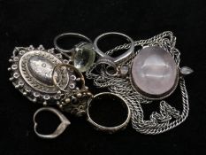 A collection of silver jewellery. To include a silver Victorian locket, a Rose quartz pendant with