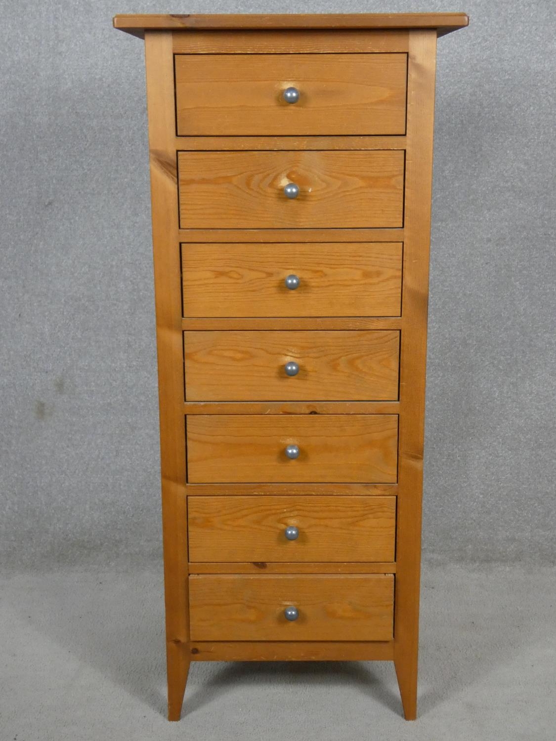 A contemporary pine narrow chest of seven drawers. H.120 W.52 D.42cm