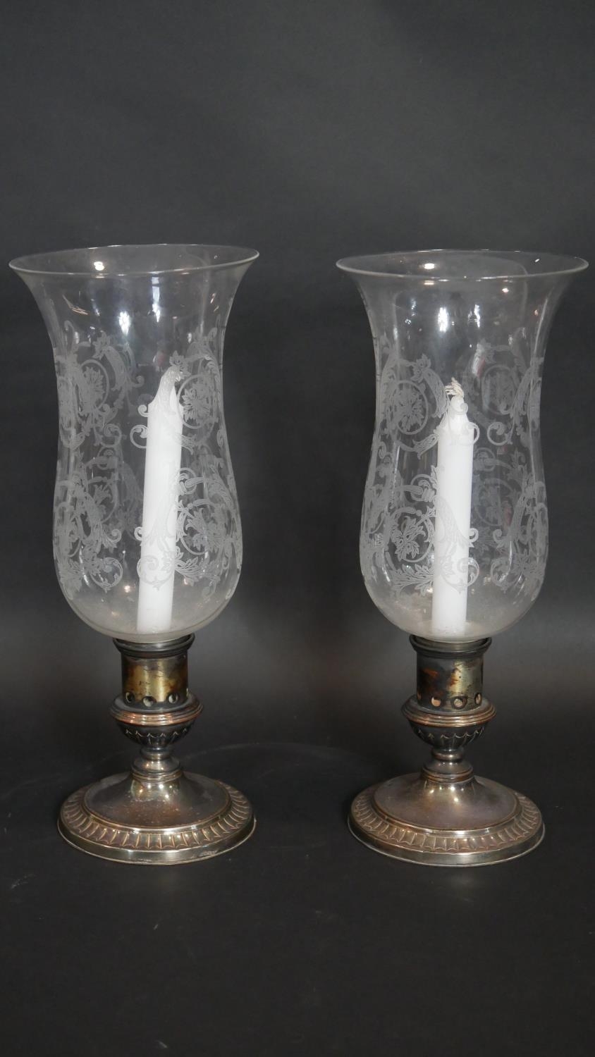 A pair of C.1900 etched glass storm lanterns on silver plated stands marked Sheffield to the base.