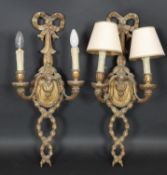 A pair of carved giltwood and gesso twin branch wall sconces with Adam style ribbon and husk swag