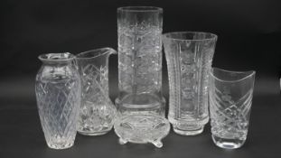 A collection of fine cut crystal items. Including four cut crystal vases, a cut crystal water jug