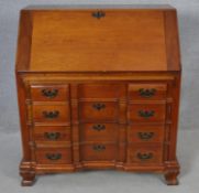 A 19th century Continental style fruitwood bureau with fully fitted interior on shaped squat bracket