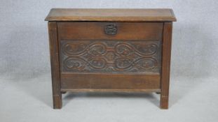 A Jacobean style small coffer with carved panels on reeded block supports. H.58 W.75 D.26cm (a piece