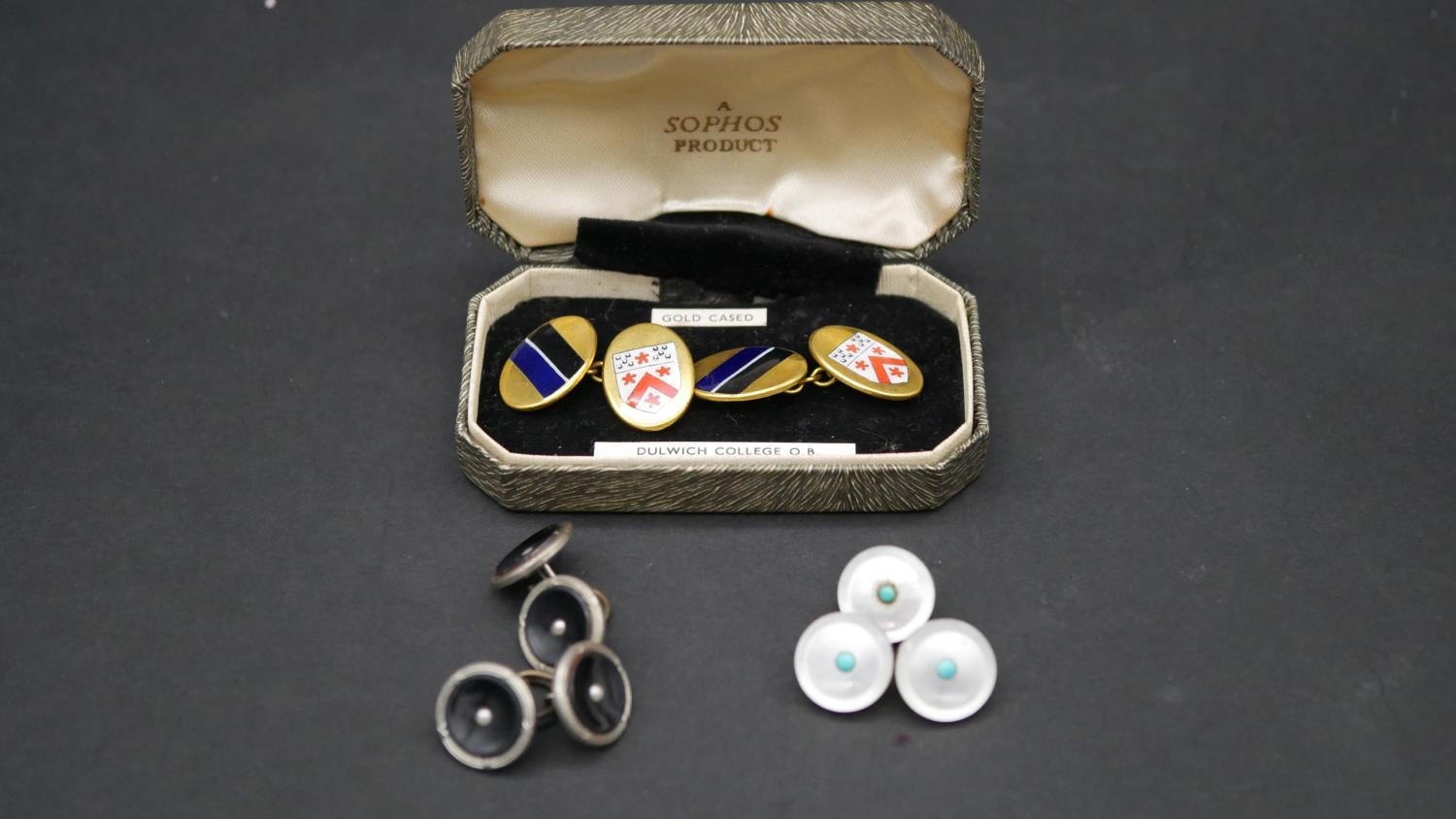 A collection of cufflinks and shirt buttons. Including a boxed set of gold cased enamel Dulwich