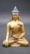 A painted gilt bronze seated Buddha. Intricately detailed. H.16cm