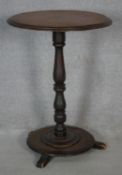 A Victorian mahogany lamp table on turned pedestal platform base. H.72 D.52cm