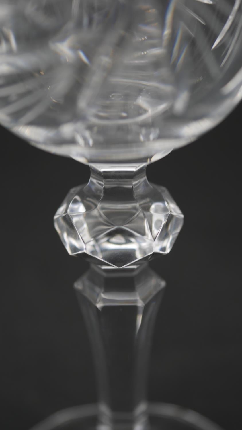 A set of eleven engraved and cut crystal wine glasses with star design and faceted stems. H.17.5cm - Image 3 of 4