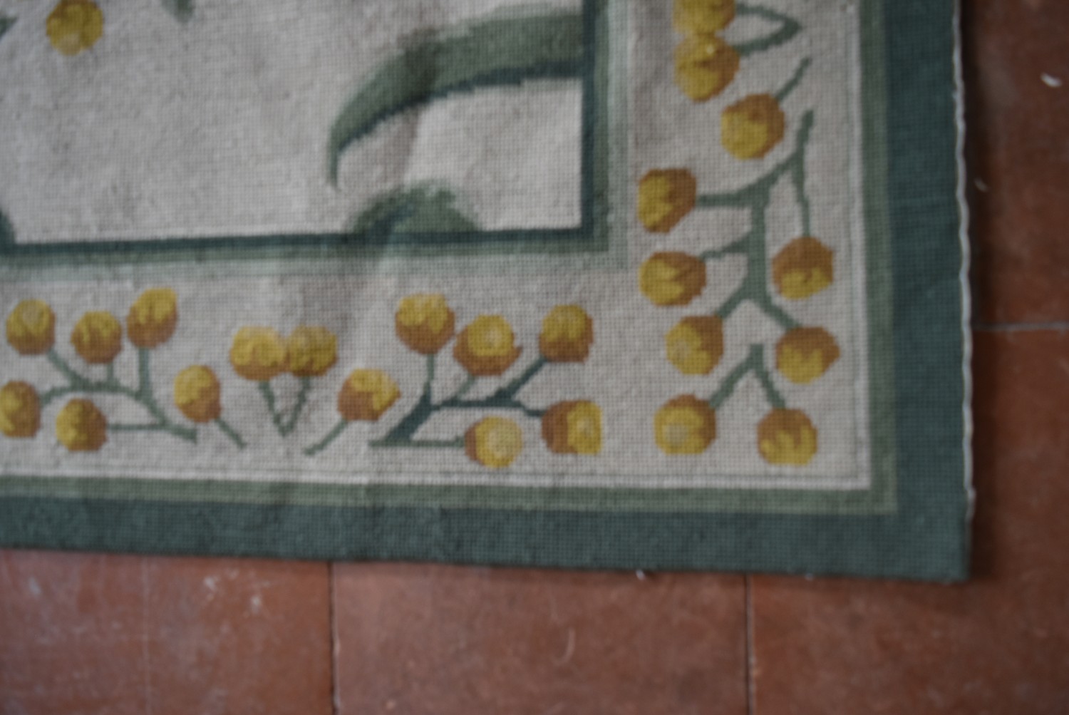 A needlepoint rug with a stylised scrolling flowering mimosa design to the central field and border. - Image 3 of 4