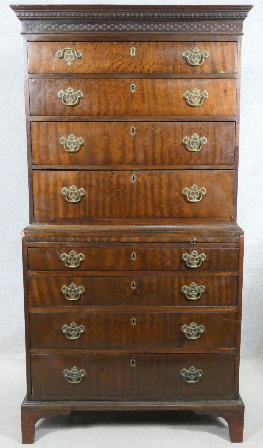 A Georgian mahogany chest on chest with blind fret cut and dentil moulded cornice above eight