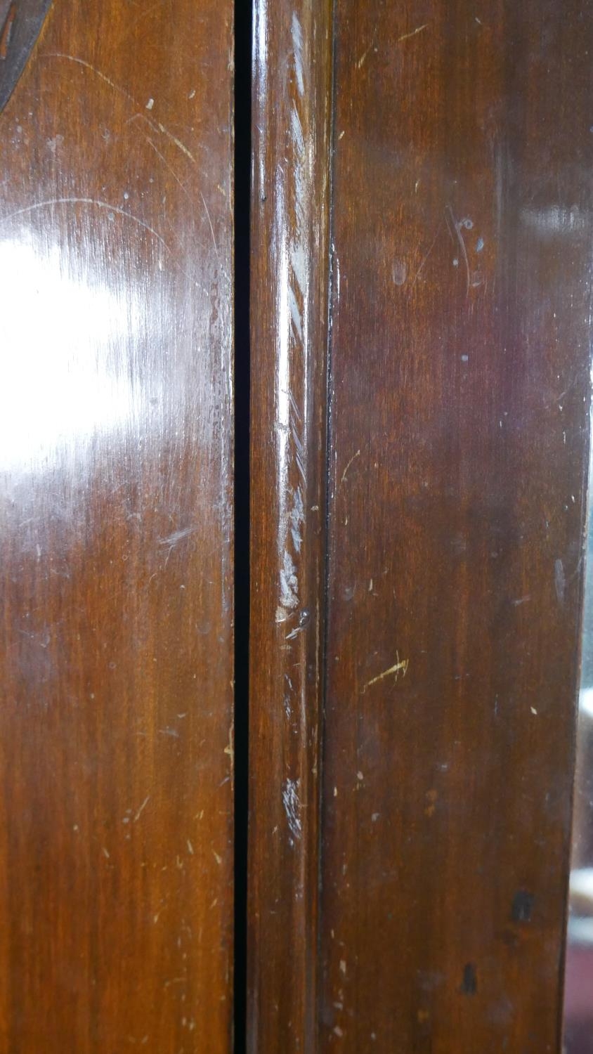 A late Victorian carved walnut wardrobe with bevelled mirrored door enclosing hanging space above - Image 16 of 23
