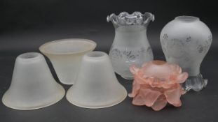 A set of three opaque glass light shades, a pair of etched bulbous shades and an Art Deco floral