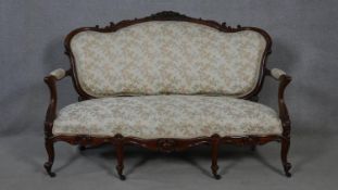 A 19th century carved mahogany canape in floral upholstery with four cabriole front supports. H.99