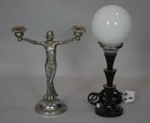 An Art Deco chrome figural two branch candelabra along with an Art Deco globe lamp on bakelite base.