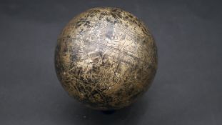 An Islamic celestial globe, engraved in brass with Islamic symbols and astrological diagrams. D.15cm