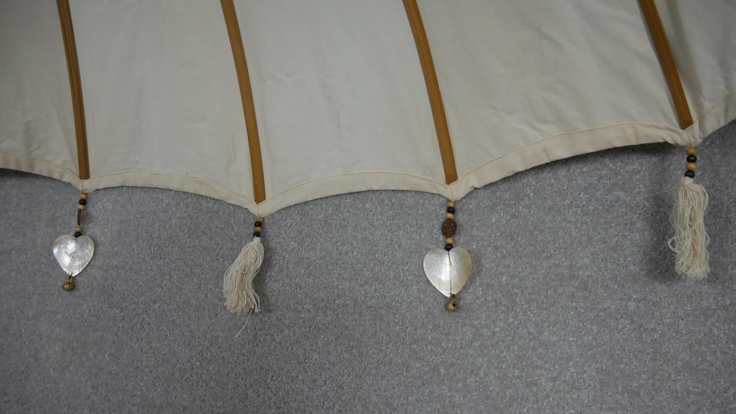 An Indian tall parasol with carved and gilt painted and decorated finial and stem and heart shell - Image 5 of 6