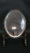 A C.1900 swing toilet mirror with bevelled plate in black lacquered Chinoiserie decorated frame. H.