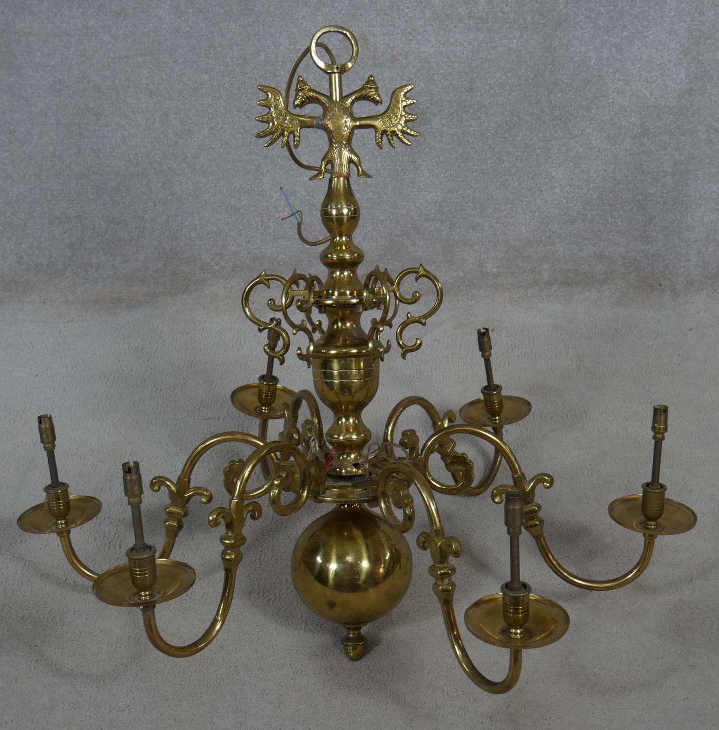A Dutch style brass six branch chandelier with double headed eagle finials and scrolling arms. D.
