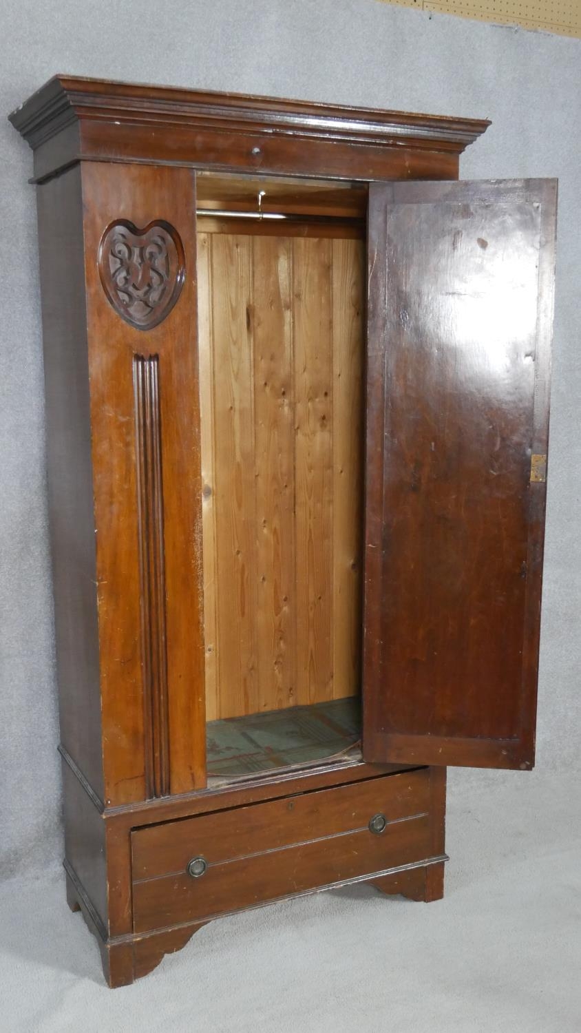 A late Victorian carved walnut wardrobe with bevelled mirrored door enclosing hanging space above - Image 4 of 23