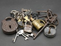 A collection of antique and vintage locks and keys. To include a large cast iron padlock with