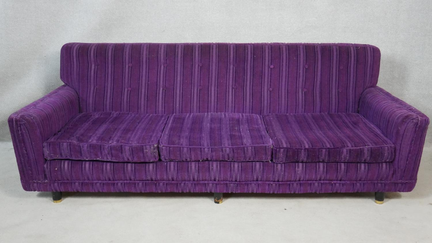 A 1970's vintage cut fabric three seater sofa on ebonised circular supports, retailed by Heal's. H.