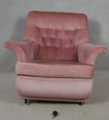 A mid century vintage open armchair in pink buttoned velour upholstery. H.78 W.94 D.78cm
