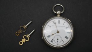 A Victorian silver pocket watch, the Accurate English Lever. With white enamel dial and black